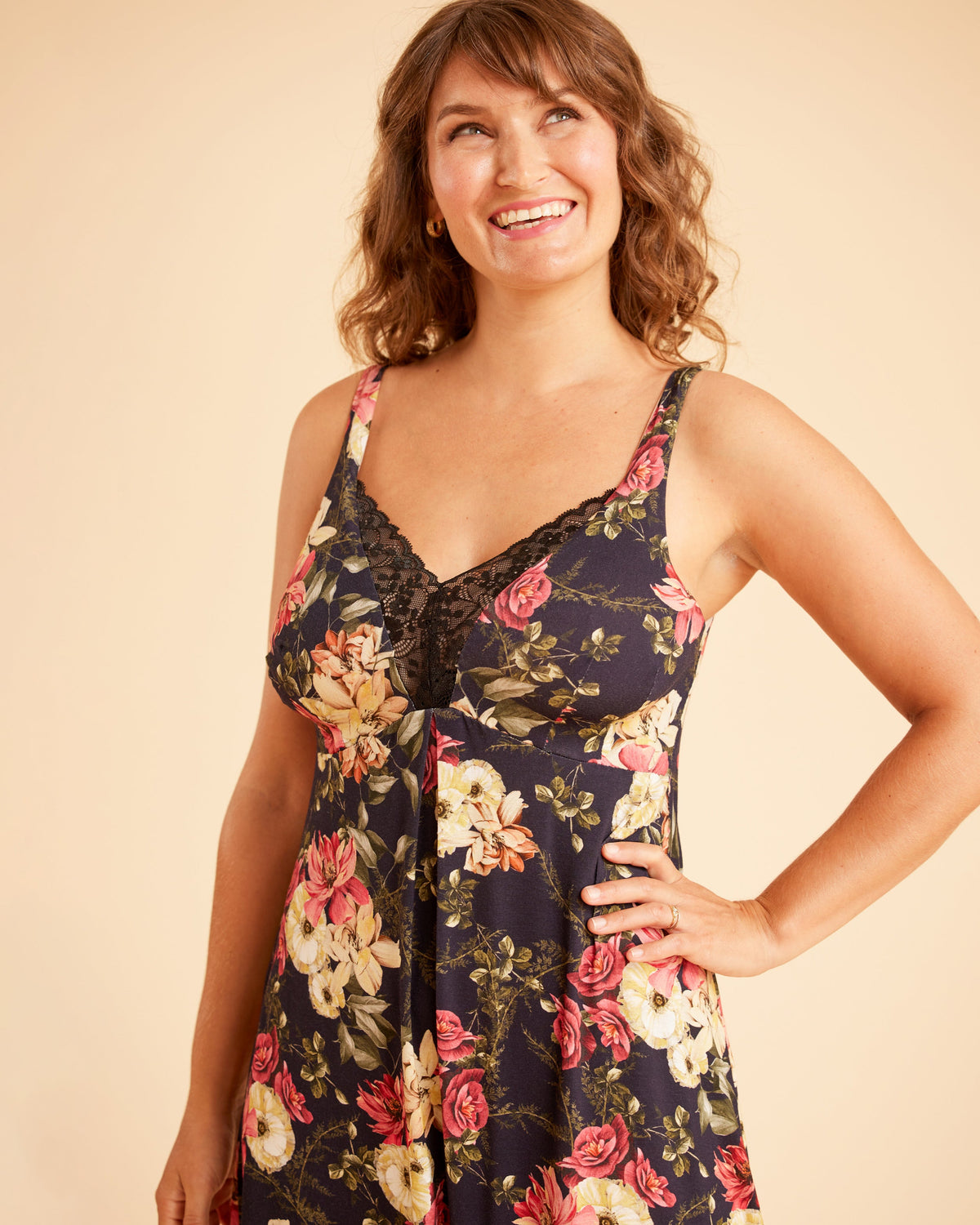 Woman wearing a floral dress against a beige background. This is the Fiske Sleepwear Set sewing pattern from Cashmerette.