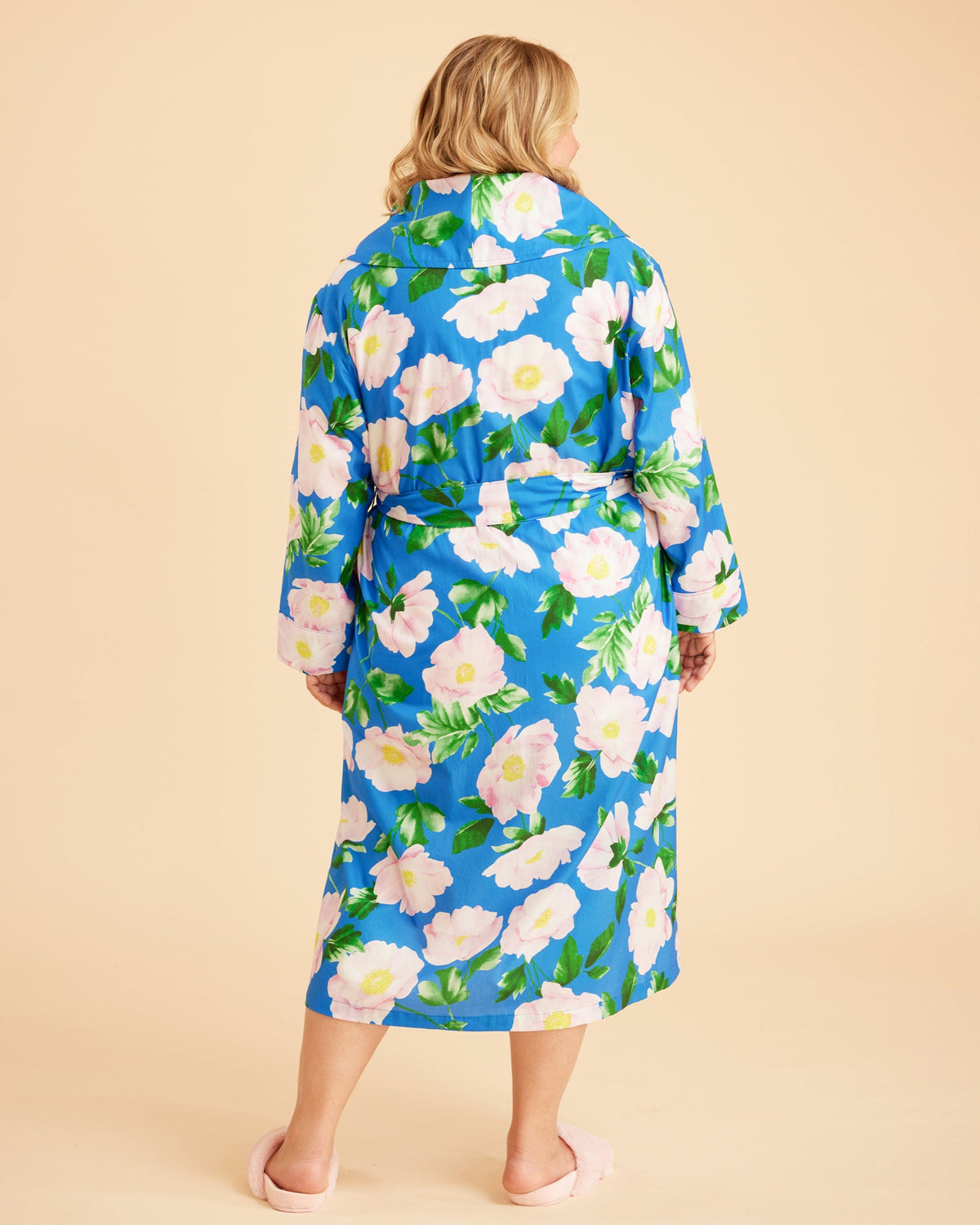 Woman wearing a blue floral robe against a beige background. This is the Fiske Sleepwear Set sewing pattern from Cashmerette.