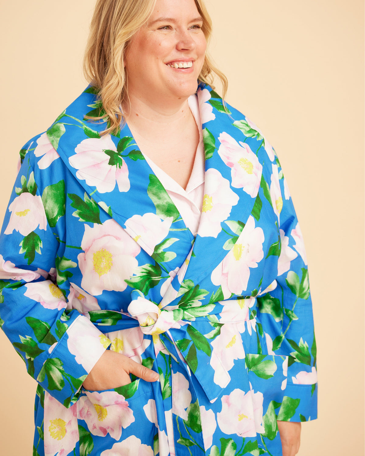Woman wearing a blue floral robe against a beige background. This is the Fiske Sleepwear Set sewing pattern from Cashmerette.