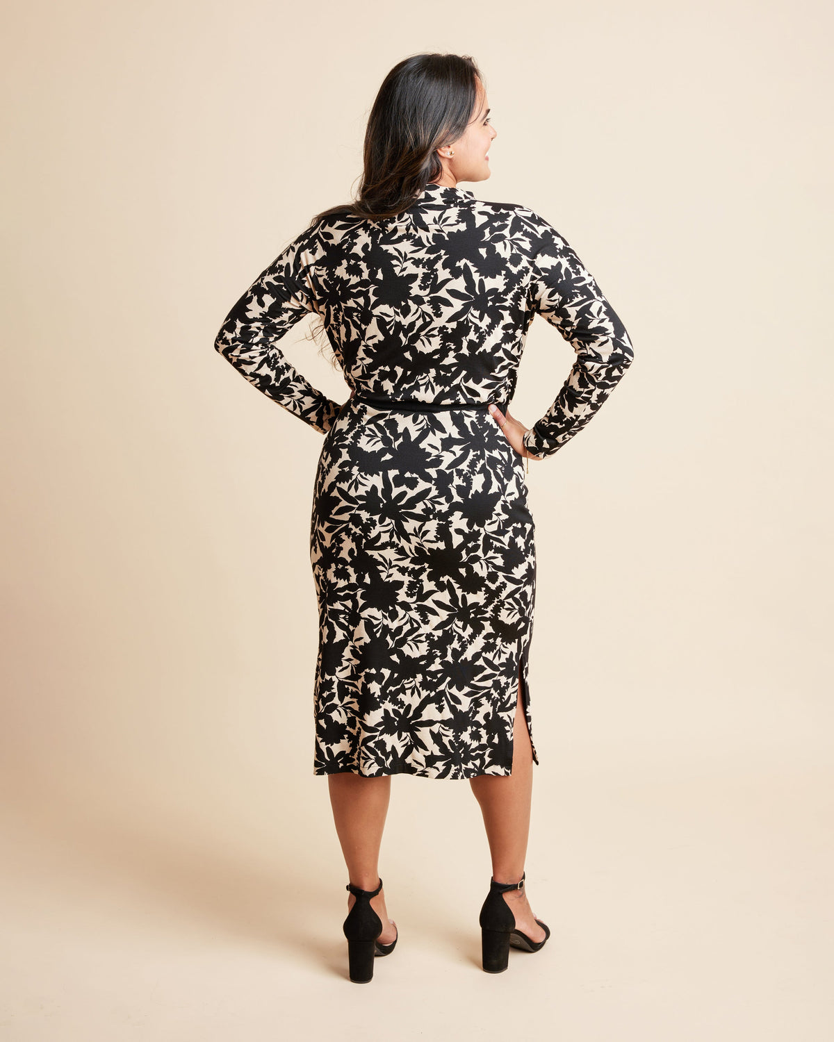 Woman wearing a black and beige floral dress against a beige background. This is the Grafton Dress, Top & Skirt sewing pattern from Cashmrette.