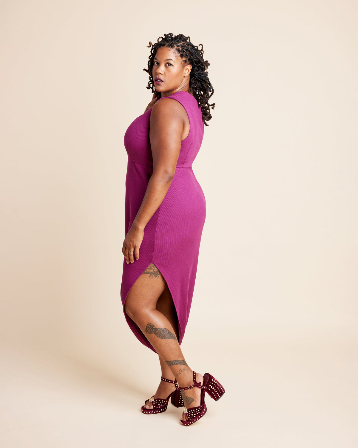 Woman wearing a magenta dress with a plain background. This is the Grafton Dress, Top & Skirt sewing pattern from Cashmerette.