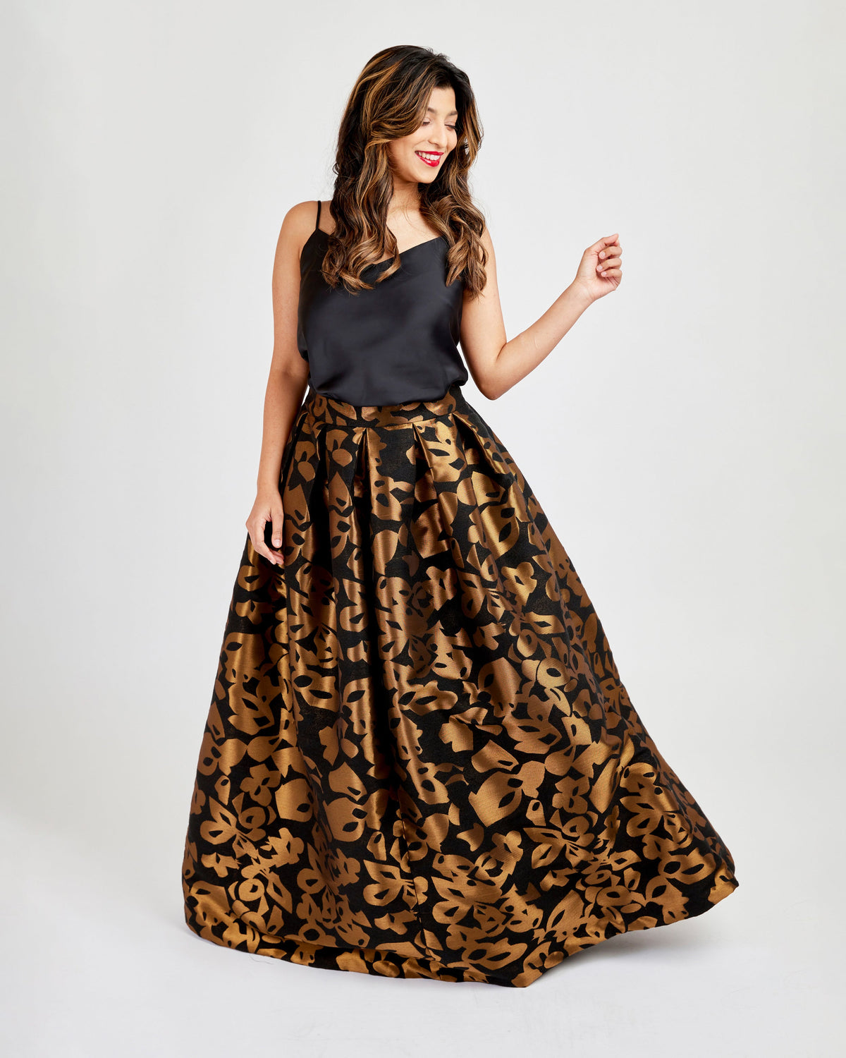 Woman wearing a black top and leopard print skirt on a white background. This skirt is the Upton Dress & Skirt sewing pattern from Cashmerette.