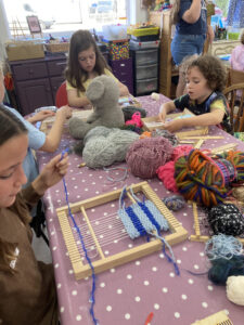 Children learning to weave