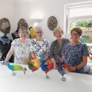 four wet-felting workshop participants with the bird they have created 